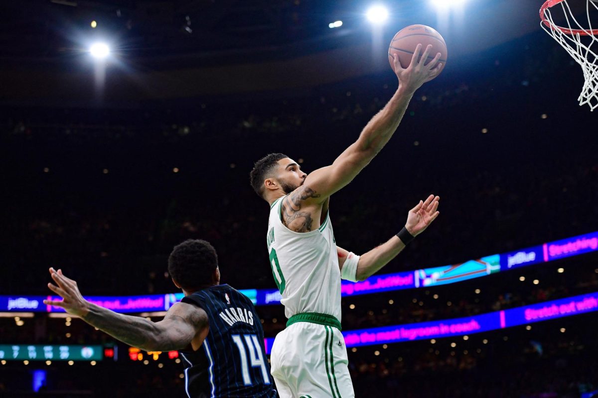 Apr 20, 2025; Boston, Massachusetts, USA; Boston Celtics forward Jayson Tatum (0) drives to the basket past Orlando Magic guard Gary Harris (14) during the second half at TD Garden. Mandatory Credit: Bob DeChiara-Imagn Images